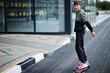 © AS Photo Family - Teenager boy in a sports suit rides on longboard.