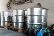 Metal and plastic barrels containing hazardous chemicals from industry, waste management concept, industrial background