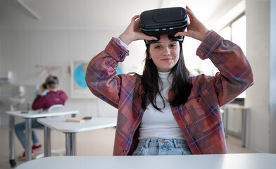 Wall Mural - happy student wearing virtual reality goggles at school in computer science class
