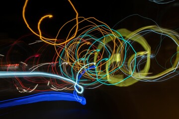 Closeup of beautiful neon colorful lights in circular motion in the dark