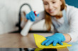 © brizmaker - Lady wiping surface with napkin and detergent