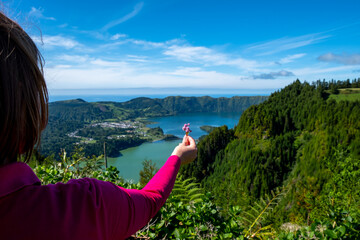 Wall Mural - Woman holds a Small Flower on the hand.  Sete Cidades Lake - 