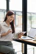 © Jirapong - Portrait of an Asian female employee using a tablet computer at work.
