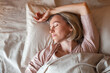 Middle aged woman sleeping in cozy bed