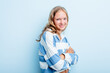 Leinwandbild Motiv Caucasian teen girl isolated on blue background who feels confident, crossing arms with determination.