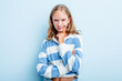 Leinwandbild Motiv Caucasian teen girl isolated on blue background unhappy looking in camera with sarcastic expression.