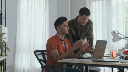 Wall Mural - medium slowmo of team of professional male indian programmers working on new software in office, loo