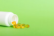 Leinwandbild Motiv Soft gels pills with Omega-3 oil spilling out of pill bottle close-up. Gel capsules bottle white surface. Omega 3, multivitamins, Calcium, antibiotics. Health. Immunity