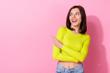 Wall Mural - photo of cheerful gorgeous girl look direct finger empty space blank isolated on pink color backgrou