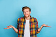 © deagreez - Portrait of stylish unhappy upset man with ginger hairstyle dressed plaid shirt showing palms empty space isolated on blue color background