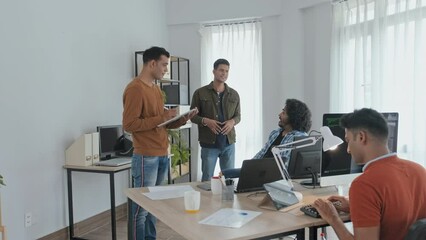 Wall Mural - slowmo of male indian programmers coworking in office, brainstorming ideas and working on computers