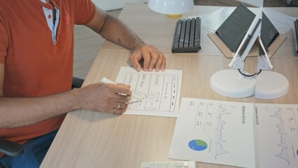 Wall Mural - cropped slowmo of unrecognizable male software developer drawing scheme on piece of paper sitting at