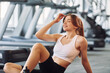 © standret - Racetracks is behind. Taking a break. Young beautiful woman in sportive clothes have fitness day in the gym
