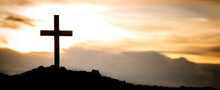 The Silhouette Cross Standing On Meadow Sunset And Flare Background. Cross On A Hill As The Morning Sun Comes Up For The Day. The Cross Symbol For Jesus Christ. Christianity, Religious, Faith, Jesus .