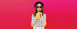 © rohappy - Portrait of stylish young woman drinking fresh juice wearing summer hat on pink background, blank copy space for advertising text