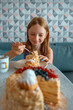 © Анна Молько - a smiling child eats a piece of cake. homemade napoleon cake decorated with berries. delicious fresh pastries, desserts, homemade treats