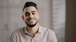 © Yuliia - Portrait of confident calm young man arabic ethnic male handsome brunet guy turn head at camera happy male human bearded face positive smiling hispanic millennial businessman shows toothy health smile