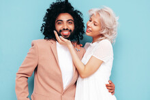 Smiling Beautiful Woman And Her Handsome Boyfriend. Sexy Cheerful Multiracial Family Having Tender Moments On Blue Background In Studio. Multiethnic Models Hugging. Embracing Each Other. Love Concept