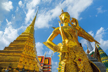 Statue Of Gods In Wat Phra Kaew, Thailand,Kinnaree Statue At Golden Pagoda At Temple Of The Emerald Buddha. Wat Phra Kaew And Grand Palace In Old Town, Urban City. Buddhist Temple, Thai Architecture.