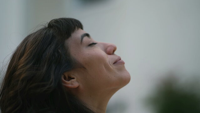 Faithful South American woman closing eyes in meditation looking at sky. Spiritual person opening eye having HOPE