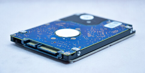 Wall Mural - Close-up view of 2.5 inch hard drive seen from the side. and empty on a white background