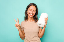 Young Hispanic Woman Holding Kitchen Roll Isolated On Blue Background Showing Number Two With Fingers.