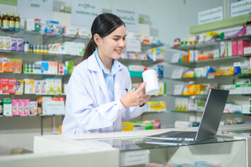 Female pharmacist counseling customer via video call in a modern pharmacy drugstore.