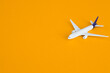 Travel concept on yellow background with copy space. Airplane toy on yellow color background.
