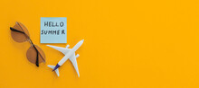Miniature Toy Airplane On Color Background And Word Hello Summer. Trip By Airplane.