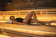 © puhimec - A young woman having rest in sauna alone.