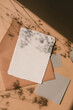 Aesthetic flat lay of handmade paper sheets with mockup copy space on terracotta background.