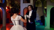 Charming Lady In Vintage Gorgeous Dress And Young Man In Tailcoat Are Dancing Waltz In Ballroom