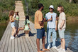 © Seventyfour - Full length portrait of three young men drinking beer outdoors in Summer setting, copy space