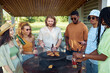 © Seventyfour - Diverse group of young people grilling meat during barbeque party outdoors in Summer and drinking beer