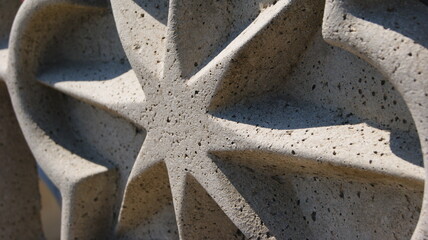 Star shaped stone fence ornament seen in detail in the sun