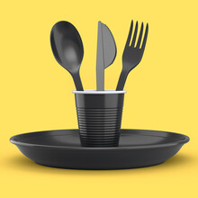 Set Of Disposable Utensils Like Plate, Folk, Spoon,knife And Cup On Yellow .