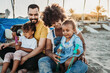 © Kelsey Smith/Stocksy - Family playing at beach
