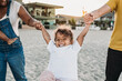 © Kelsey Smith/Stocksy - Family walking on beach