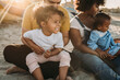 © Kelsey Smith/Stocksy - Little girl laughing with family