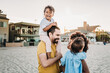 © Kelsey Smith/Stocksy - Family laughing at beach