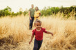 © Kelsey Smith/Stocksy - Toddler Running from parents