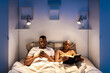 © Ezequiel Giménez/Stocksy - Black couple resting on bed before sleep