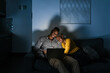 © Ezequiel Giménez/Stocksy - Black couple watching film at night