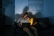 © Ezequiel Giménez/Stocksy - Black couple using laptop late at night