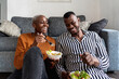 © Ezequiel Giménez/Stocksy - Beloved black couple having lunch in living room