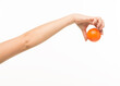 © serhii - female hands holding an orange sponge ball on a white background isolated