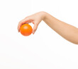 © serhii - female hands holding an orange sponge ball on a white background isolated