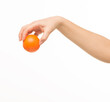 © serhii - female hands holding an orange sponge ball on a white background isolated