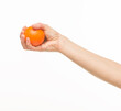 © serhii - female hands holding an orange sponge ball on a white background isolated