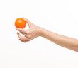 © serhii - female hands holding an orange sponge ball on a white background isolated